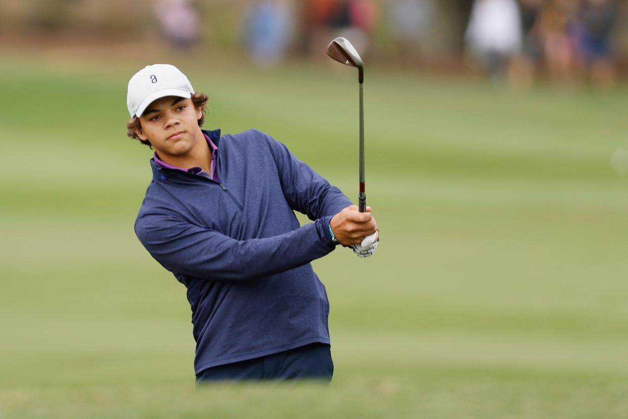 Charlie Woods, son of Tiger Woods, plays his shot on the 18th hole during the pro-am before the PNC Championship.