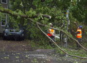 Workers remove a fallen tree blocking a road in Dartmouth, Nova Scotia. as Hurricane Dorian approaches on Saturday, Sept. 7, 2019. Despite gradually transitioning to a post-tropical storm, Dorian will continue to be as strong as a Category 1. (Andrew Vaughan/The Canadian Press via AP)