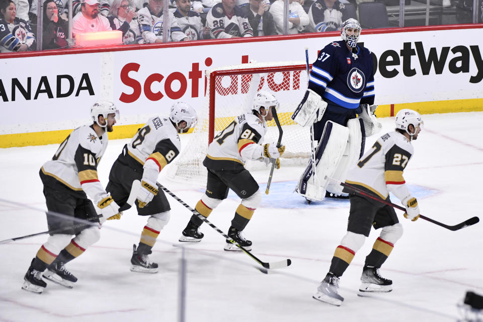 Winnipeg Jets' goaltender Connor Hellebuyck (37) looks on as the Vegas Golden Knights celebrate after their second goal, during second-period Game 4 NHL Stanley Cup first-round hockey playoff action in Winnipeg, Manitoba, Monday April 24, 2023. (Fred Greenslade/The Canadian Press via AP)