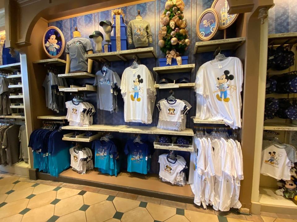 50th anniversary section in a disney world gift shop with shirts and other apparel