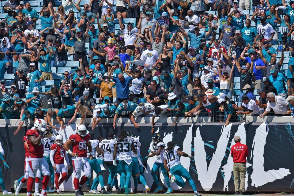 Fans celebrate with Jaguar players in the North end zone after Jacksonville Jaguars wide receiver Jamal Agnew (39) ran the ball 109 yards for a touchdown after catching a missed field goal attempt by the Arizona Cardinals at the end of the second quarter of play. The Jacksonville Jaguars hosted the Arizona Cardinals at TIAA Bank Field in Jacksonville, FL Sunday, September 26, 2021. The Jaguars went into the half with a 13 to 7 lead. [Bob Self/Florida Times-Union]