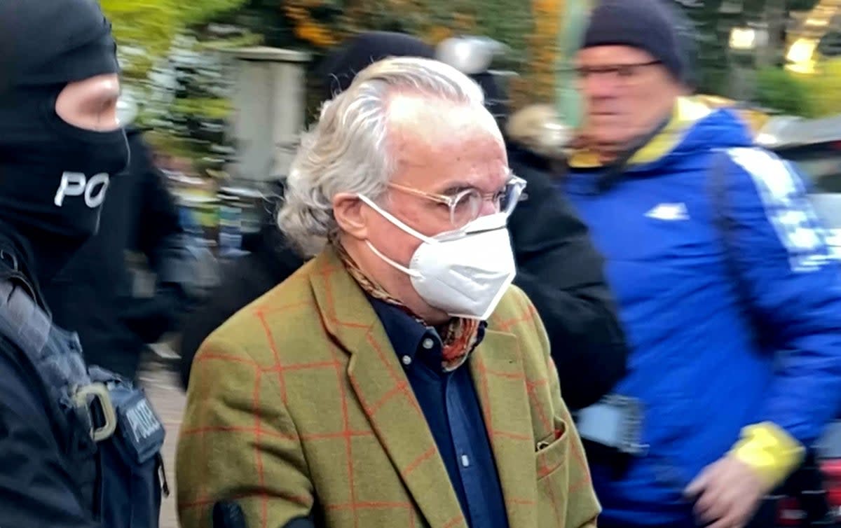 Police escort Prince Heinrich XIII after he was detained in Frankfurt (REUTERS)