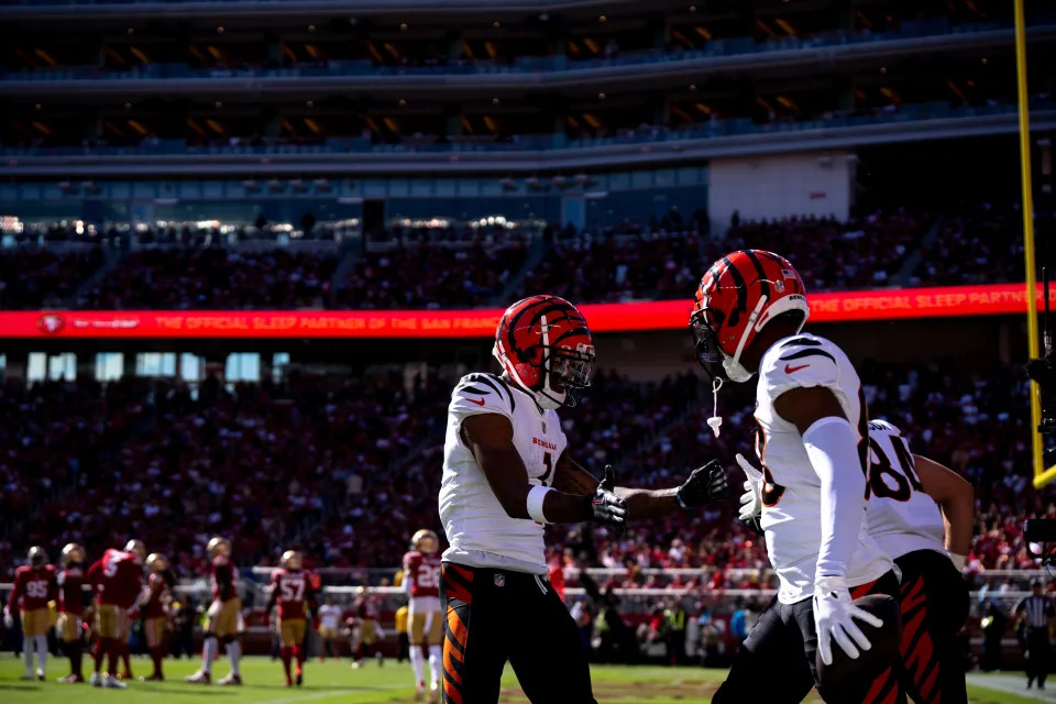 Wide receiver Ja'Marr Chase (1) congratulates wide receiver Tyler Boyd after Boyd scored the Bengals' first  touchdown in the first quarter. Albert Cesare/The Enquirer