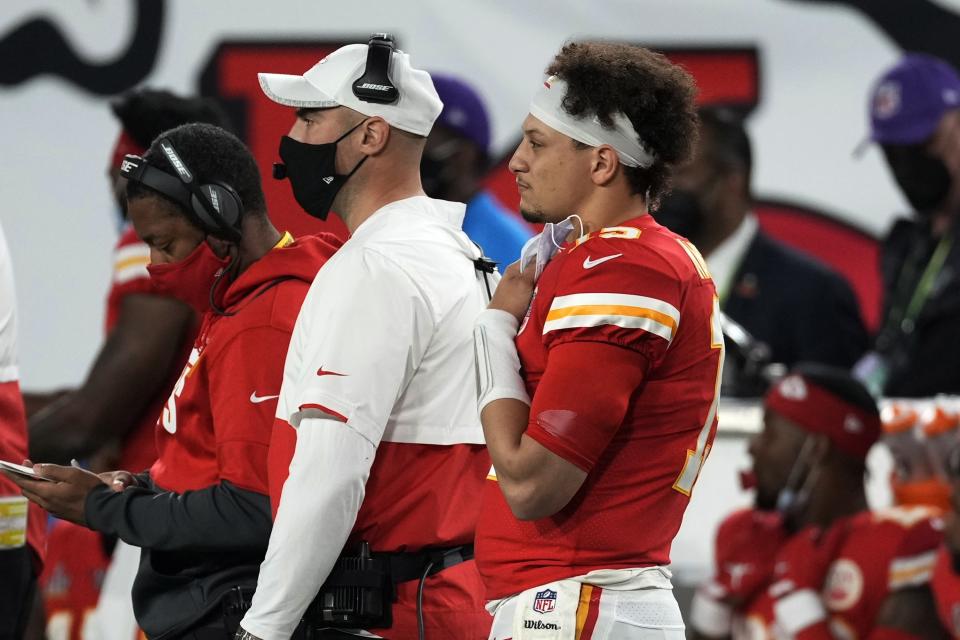 Kansas City Chiefs quarterback Patrick Mahomes, foreground, watches from the bench during the second half of the NFL Super Bowl 55 football game against the Tampa Bay Buccaneers Sunday, Feb. 7, 2021, in Tampa, Fla. (AP Photo/Chris O'Meara)