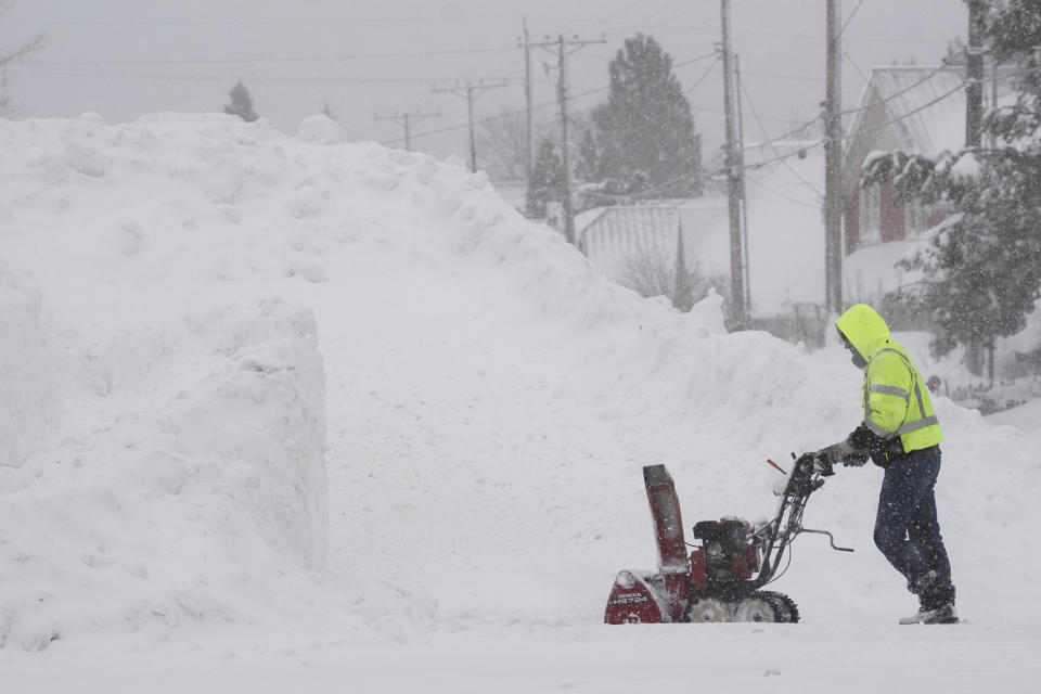 A man uses a snow blower as snow piles up during a storm, Sunday, March 3, 2024, in Truckee, Calif. (AP Photo/Brooke Hess-Homeier)