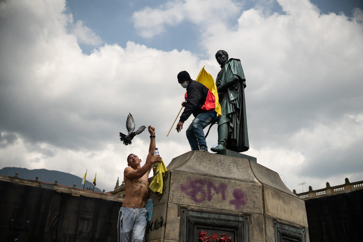 Protesters climb the sculpture of Simon Bolivar, thousands of Colombians take to the streets to protest against the government and the tax reform that would raise taxes on basic foodstuffs. Picture by Andrés Cardona.