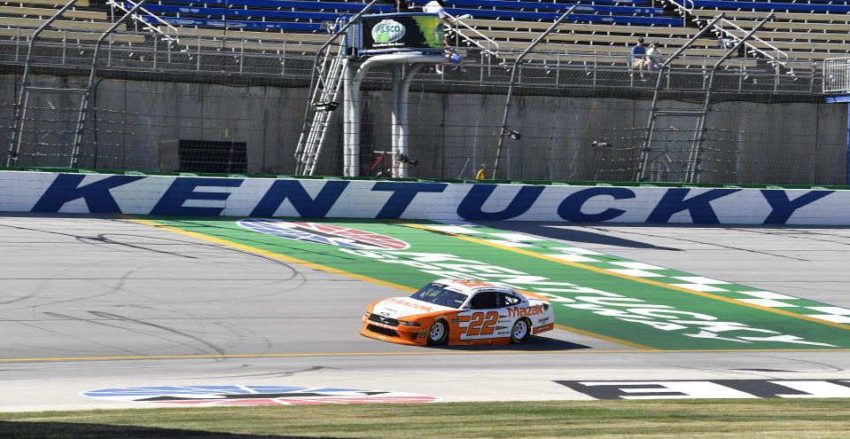 Austin Cindric (22) crosses the finish line to take the pole for an Xfinity Series auto race at Kentucky Speedway in Sparta, Ky., Friday, July 12, 2019. (AP Photo/Timothy D. Easley)