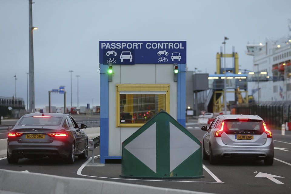 Cars bearing British license plates stop at a passport control booth at the transit zone at the port of Ouistreham, Normandy, Thursday, Sept.12, 2019. France has trained 600 new customs officers and built extra parking lots arounds its ports to hold vehicles that will have to go through extra checks if there is no agreement ahead of Britain's exit from the EU, currently scheduled on Oct. 31. (AP Photo/David Vincent)