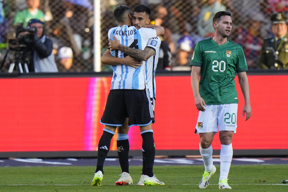 Argentina's Nicolas Gonzalez embraces teammate Exequiel Palacios after scoring his side's third goal against Bolivia during a qualifying soccer match for the FIFA World Cup 2026 at Hernando Siles stadium in La Paz, Bolivia, Tuesday, Sept. 12, 2023. (AP Photo/Gaston Brito)