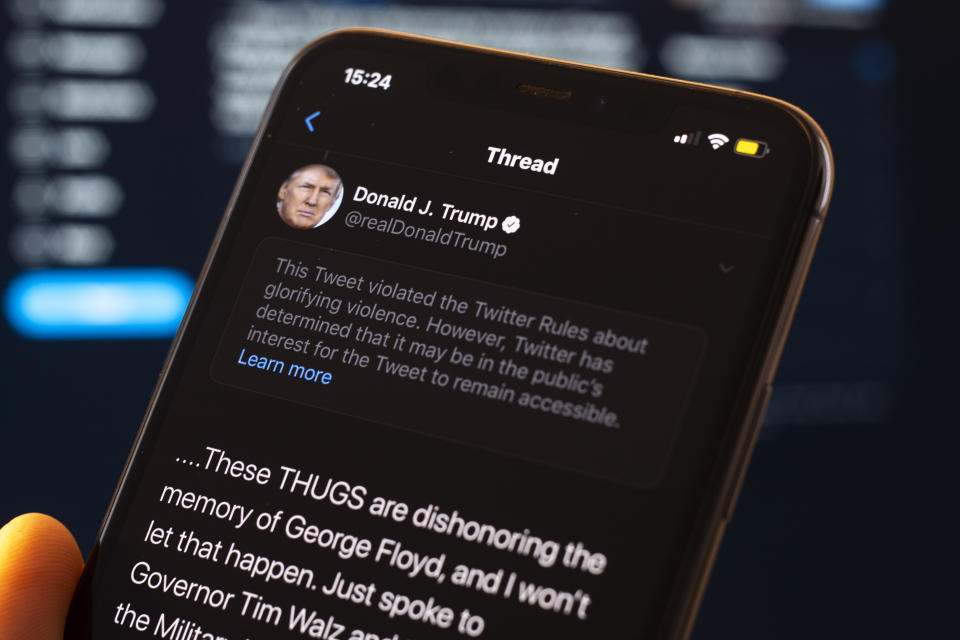 A tweet by US president Donald Trump is seen being flagged as inciting violence by Twitter in this photo illustration on an Apple iPhone in Warsaw, Poland on May 29, 2020. Twitter on May 29 applied a fact-checking label to a vote-in-mail tweet by US President Donald Trump that the company considers misleading. Twitter has recently started labelling tweets with public notification and fact check labels. The labelling of Trump's tweet about the uproar following the death of George Floyd has seen the president signing an executive order targeting the Communications Decency Act. Section 230 which protects social media companies against lawsuits against them for user generated content. (Photo Illustration by Jaap Arriens/NurPhoto via Getty Images)