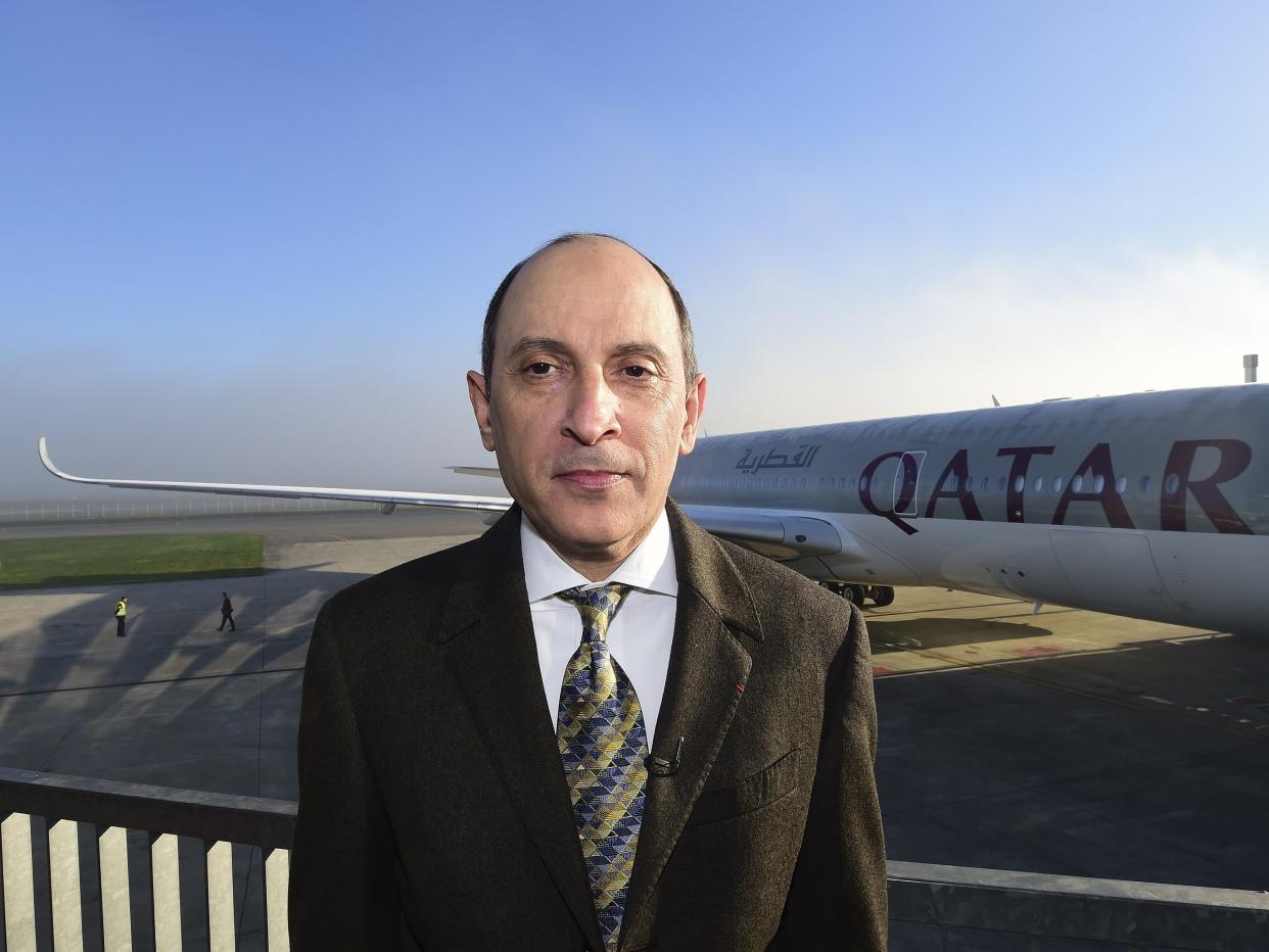 Qatar Airways CEO Akbar Al Baker poses near an Airbus A350-900 aircraft.