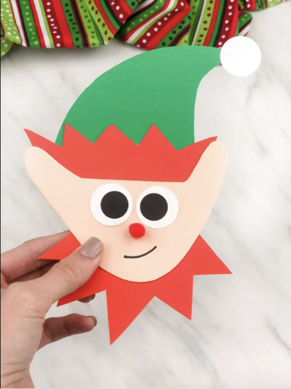 <p>If you're crafting with a toddler, this adorable elf card is a great option. Use the shape of their handprint to make the face, then cut out a hat and neck trim on colored card stock. </p><p><a href="https://www.simpleeverydaymom.com/elf-handprint-christmas-card/" rel="nofollow noopener" target="_blank" data-ylk="slk:Get the tutorial from Simple Everyday Mom »;elm:context_link;itc:0;sec:content-canvas" class="link "><em>Get the tutorial from Simple Everyday Mom »</em></a></p>