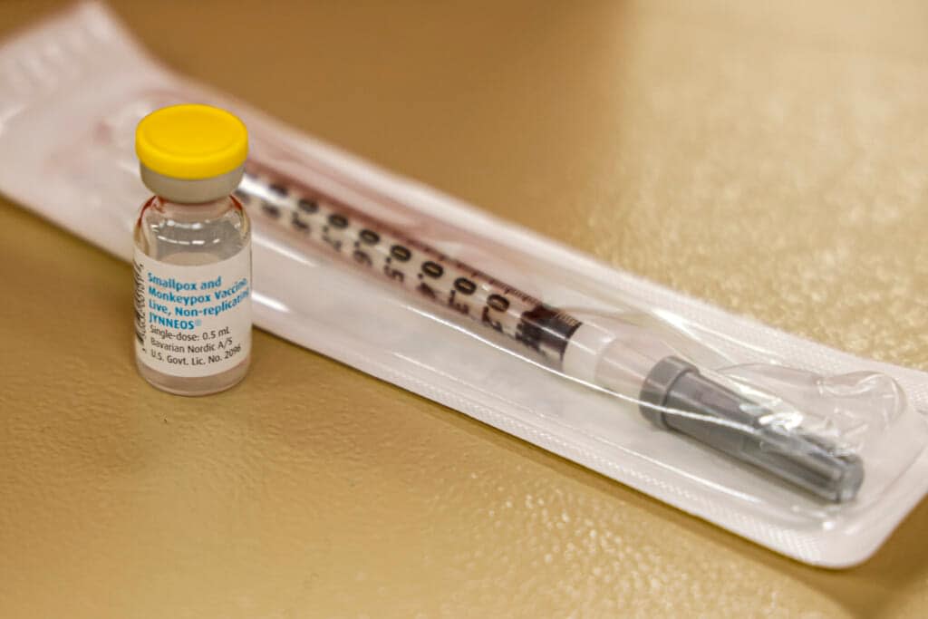 A vial containing the monkeypox vaccine and a syringe is set on the table at a vaccination clinic run by the Mecklenburg County Public Health Department in Charlotte, N.C., Saturday, Aug. 20, 2022. (AP Photo/Nell Redmond, File)