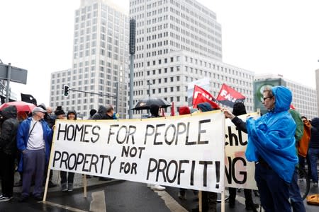 FILE PHOTO: Protesters hold a banner during a demonstration against rising rents and gentrification in Berlin