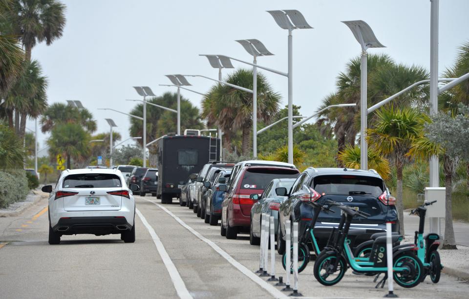 Drivers take advantage of free parking along Benjamin Franklin Dr. next to Lido Beach in Sarasota.