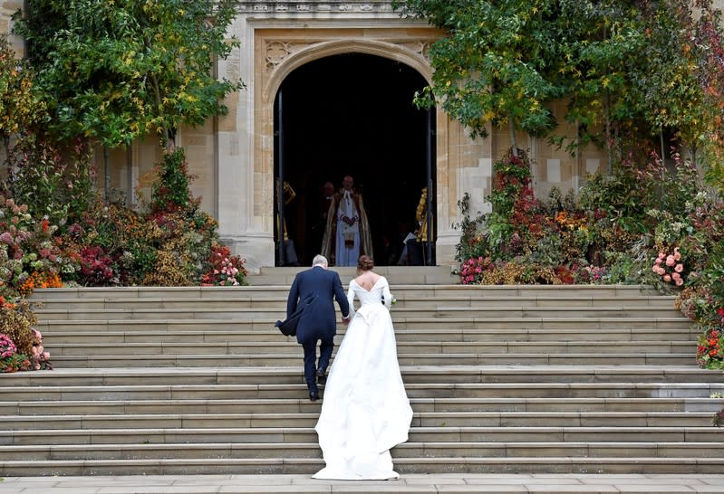 FILE PHOTO: Britain's Princess Eugenie arrives accompanied by her father Prince Andrew, Duke of York, at St George's Chapel for her wedding to Jack Brooksbank in Windsor Castle, Windsor