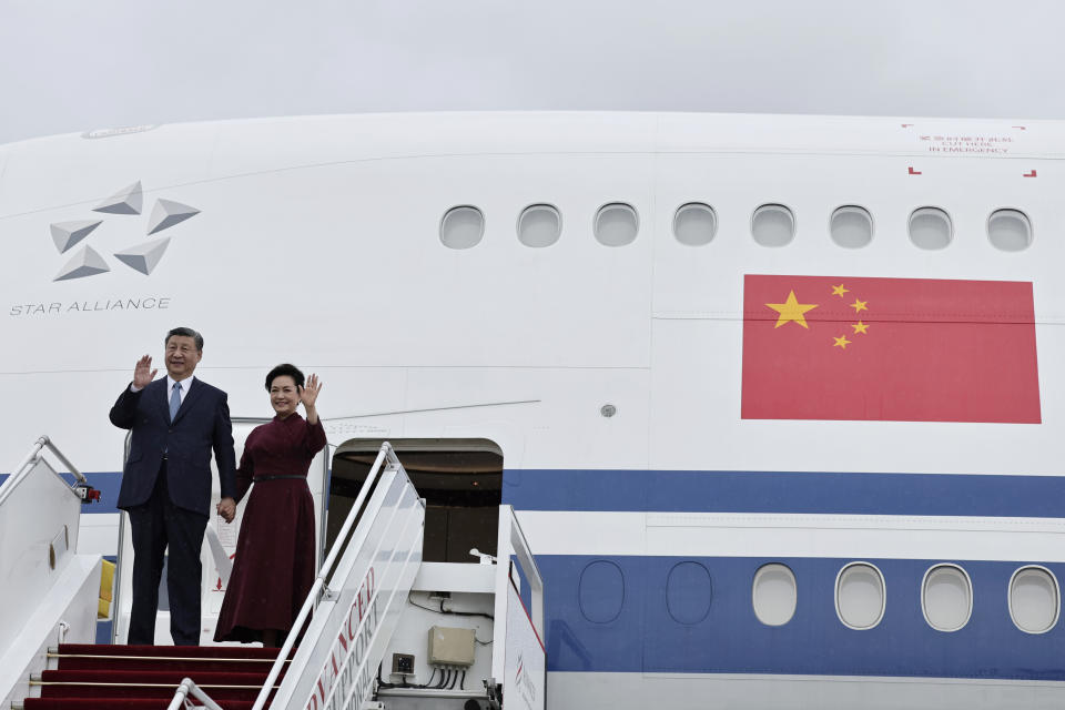 Chinese President Xi Jinping and his wife Peng Liyuan wave as they arrive at Orly airport, south of Paris, Sunday, May 5, 2024. Chinese President Xi Jinping kicked off a three-country trip to Europe on Sunday with the continent divided over how to deal with Beijing's growing power and the U.S.-China rivalry. (Stephane de Sakutin, Pool via AP)