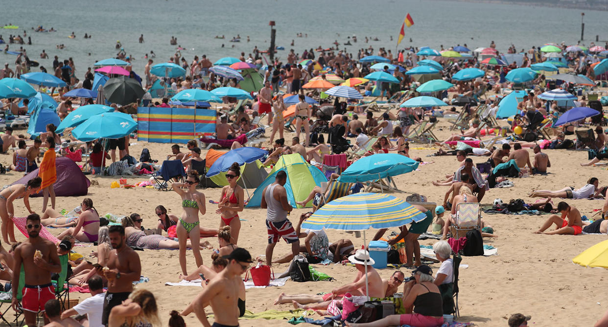 People soak up the sun on Bournemouth Beach on the hottest July day ever in the UK. (PA)