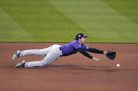 Colorado Rockies third baseman Josh Fuentes is unable to reach a single by St. Louis Cardinals' Tommy Edman during the fifth inning of a baseball game Friday, May 7, 2021, in St. Louis. (AP Photo/Jeff Roberson)