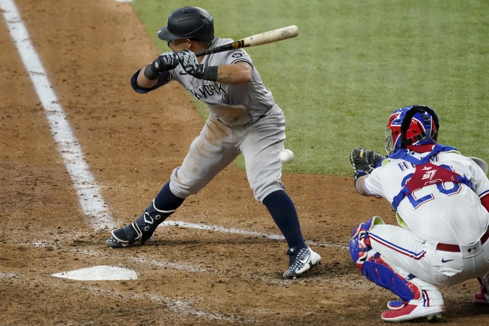 New York Yankees' Rougned Odor, left, is hit by a pitch from Texas Rangers relief pitcher John King as catcher Jonah Heim (28) reaches for the throw in the seventh inning of a baseball game in Arlington, Texas, Thursday, May 20, 2021. (AP Photo/Tony Gutierrez)