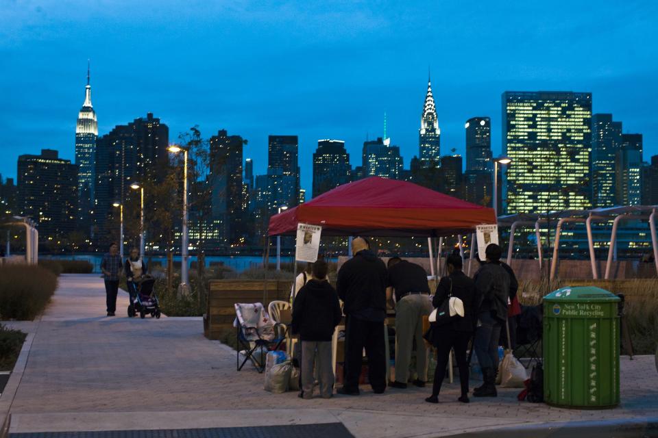 People collect information at a tent after attending a vigil for Avonte Oquendo, who is missing, in Queens, New York