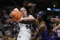 Iowa's McKenna Warnock and LSU's Flau'jae Johnson go after a loose ball during the first half of the NCAA Women's Final Four championship basketball game Sunday, April 2, 2023, in Dallas. (AP Photo/Tony Gutierrez)