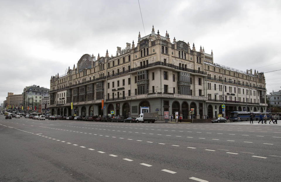 People walk near Moscow's Metropol Hotel on Thursday, Aug. 30, 2012. Michael Jackson slept there. Vladimir Lenin harangued Bolsheviks there. Over the past century, the Hotel Metropol has seen the extremes of Russian life, from austere revolutionary fervor to flashy pop indulgence. Now, at a starting price of 8.7 billion rubles ($272 million), the hotel is up for sale Thursday, auctioned off by the Moscow city government as part of its privatization program. (AP Photo/Alexander Zemlianichenko)