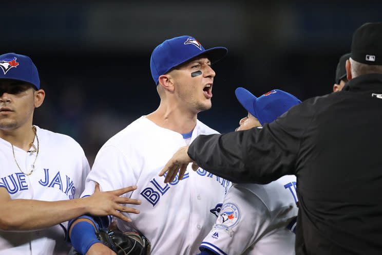 TORONTO, CANADA - SEPTEMBER 12: Troy Tulowitzki #2 of the Toronto Blue Jays takes exception to the reaction of Steven Souza Jr. #20 of the Tampa Bay Rays after the final out of the game as Devon Travis #29 and first base umpire Bill Welke #52 hold him back during MLB game action on September 12, 2016 at Rogers Centre in Toronto, Ontario, Canada. (Photo by Tom Szczerbowski/Getty Images)