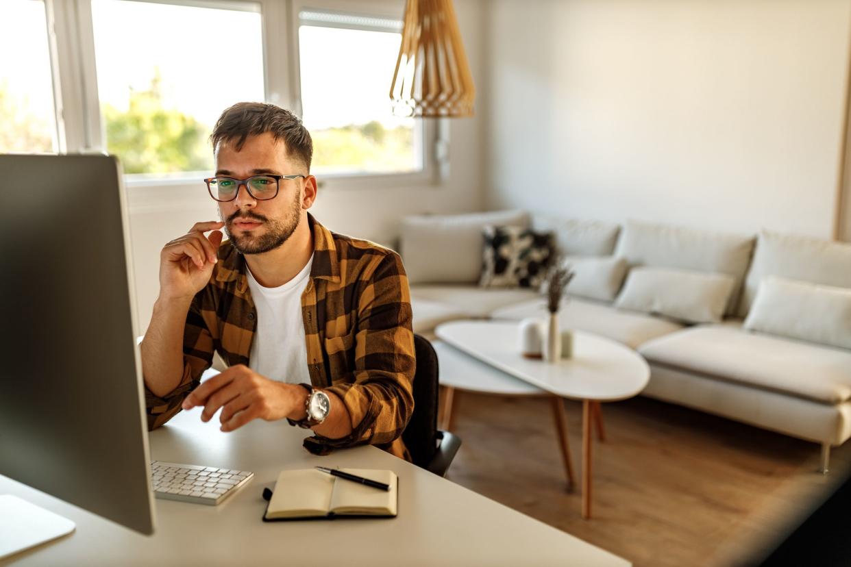 Man focused on his work, notebook and pen on the table.