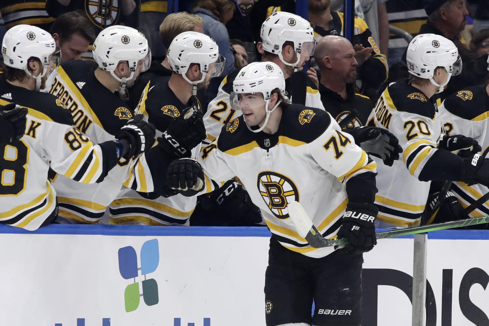 Boston Bruins left wing Jake DeBrusk (74) celebrates with the bench after scoring against the Tampa Bay Lightning during the second period of an NHL hockey game Tuesday, March 3, 2020, in Tampa, Fla. (AP Photo/Chris O'Meara)