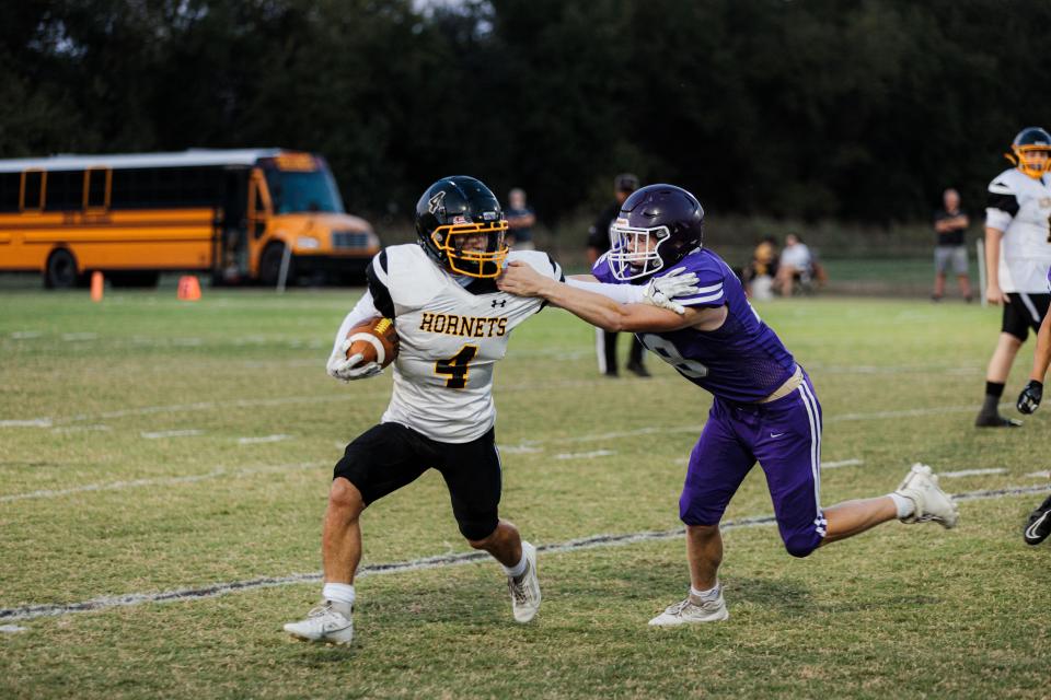 Copan's Weston O’Rourke fights with a Wesleyan defender during a September 2023 game at John White Memorial Field.