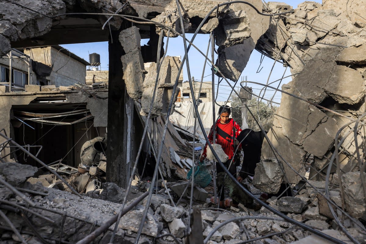 A woman and a girl search for items through the rubble of a collapsed building in Rafah in the southern Gaza Strip on April 24, 2024. Former house speaker Nancy Pelosi condemned Netanyahu for his actions in the territory on Wednesday (AFP via Getty Images)
