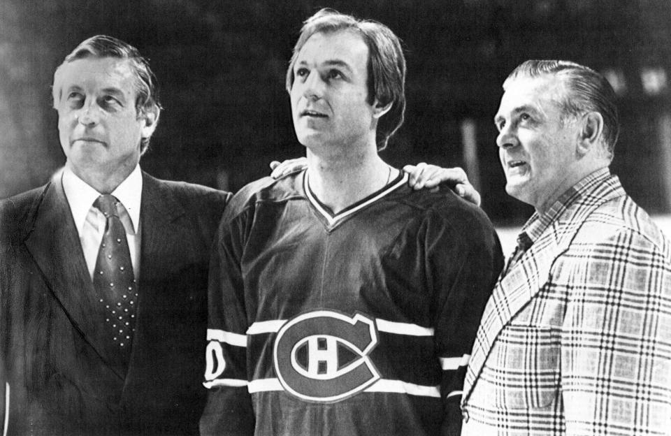 FILE - Former Montreal Canadians' Jean Beliveau, left, and and Maurice Richard, right, flank Canadiens Guy Lafleur at the Forum in Montreal, April 12, 1979. Hockey Hall of Famer Guy Lafleur, who helped the Montreal Canadiens win five Stanley Cup titles in the 1970s, died Friday, April 22, 2022, at age 70. (AP Photo/Doug Ball, File)