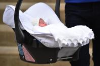 Britain's Prince William, Duke of Cambridge, carries his newly-born daughter, his second child with Catherine, Duchess of Cambridge, as they leave the Lindo Wing at St Mary's Hospital in central London, on May 2, 2015