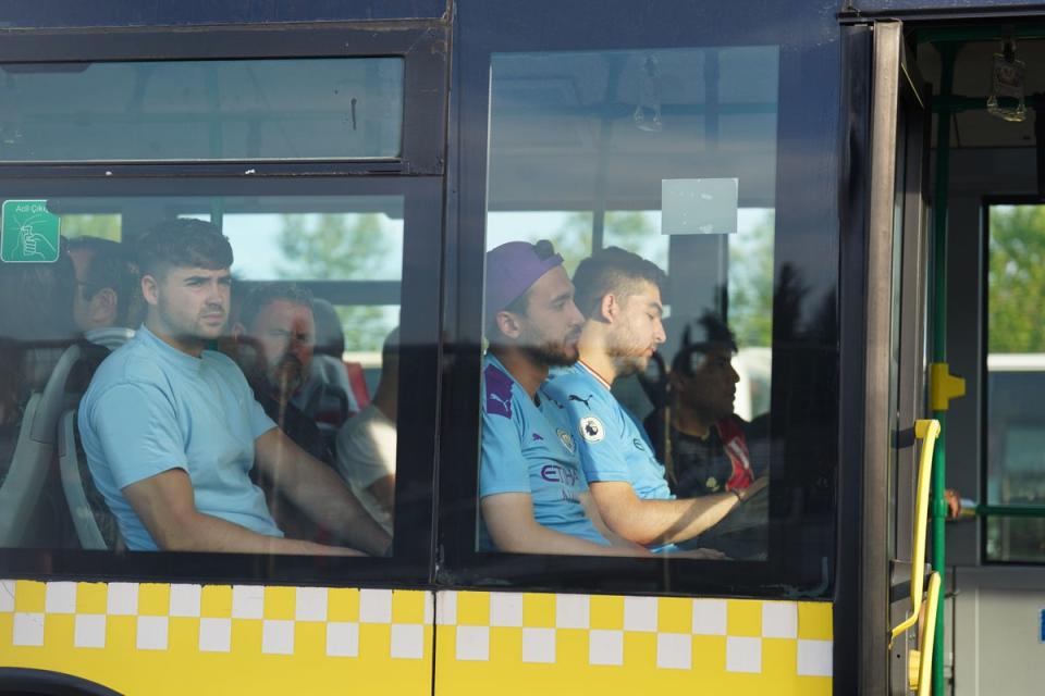 Man City fans on a shuttle bus as they head to Ataturk Olympic Stadium (PA)