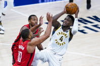 Indiana Pacers guard Victor Oladipo (4) shoots over Houston Rockets guard Eric Gordon (10) during the second quarter of an NBA basketball game in Indianapolis, Wednesday, Jan. 6, 2021. (AP Photo/Michael Conroy)