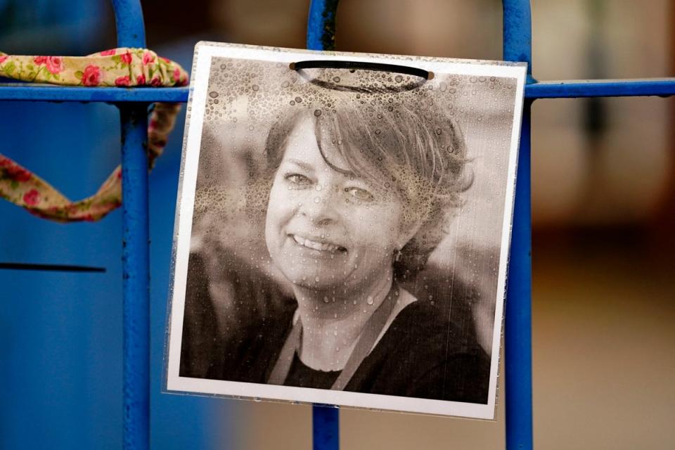 A photograph of Ruth Perry attached to the fence outside John Rankin Schools in Newbury, Berkshire (PA)