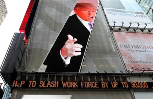 An image of Donald Trump is seen above a message board announcing job cuts at Hewlett-Packard in New York's Times Square on May 17. The move came as the California-based firm reported a 31% drop in profits in its second fiscal quarter to $1.6 bn