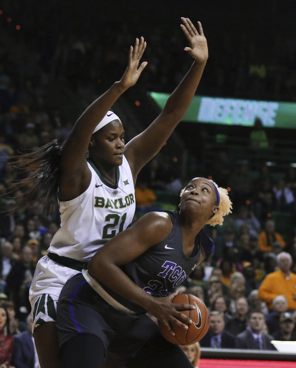 TCU center Jordan Moore, right, looks to the basket while being guarded by Baylor center Kalani Brown, left, in the first half of an NCAA college basketball game, Saturday, Feb. 9, 2019, in Waco, Texas. (AP Photo/Rod Aydelotte)