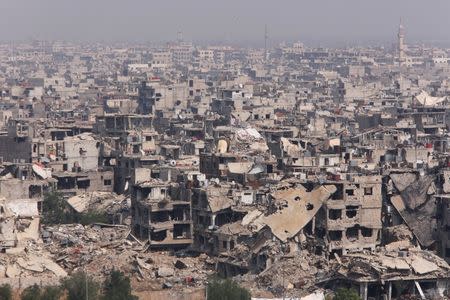 Damaged buildings are seen at the Yarmouk Palestinian camp in Damascus, Syria April 28, 2018. REUTERS/Omar Sanadiki/Files