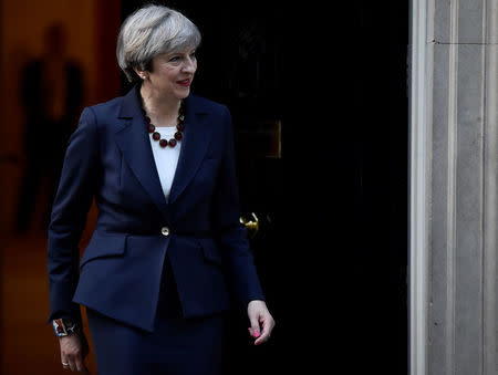 Britain's Prime Minister Theresa May walks out of 10 Downing Street to welcome Head of the European Commission, President Jean-Claude Juncker to Downing Street in London, Britain April 26, 2017. REUTERS/Hannah McKay