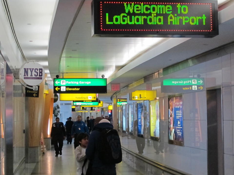 In this Jan. 10, 2014 photo, passengers maneuver through one of the cramped hallways at New York's LaGuardia Airport. Often ranked in customer satisfaction surveys as the worst airports in America, New York Gov. Andrew Cuomo says the state is taking control of an ambitious $3.6 billion construction project at LaGuardia that calls for an entirely new Central Terminal Building. (AP Photo/Frank Eltman)