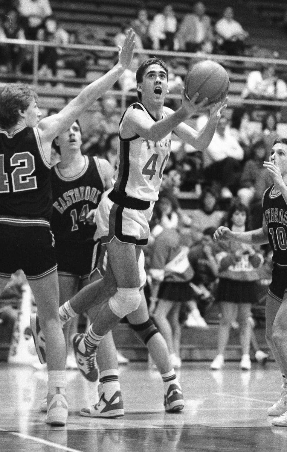 File - Current United Auto Workers President Shawn Fain, is shown driving for a layup as a high school basketball player during a game at Taylor High School in Kokomo, Ind., on Feb. 10, 1987. With roots in small-town Indiana, Fain, now 54, was known as a straight-arrow young man who respected teachers and coaches at Taylor High School, from which he graduated in 1987. (AP Photo via Kokomo Tribune, Paul Sancya, File)