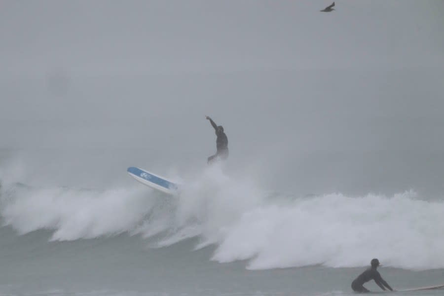 Surfers ride waves at Doheny State Park Beach in Dana Point, Calif., Sunday, Aug. 20, 2023. Tropical Storm Hilary swirled northward Sunday just off the coast of Mexico's Baja California peninsula, no longer a hurricane but still carrying so much rain that forecasters said "catastrophic and life-threatening" flooding is likely across a broad region of the southwestern U.S. (AP Photo/Damian Dovarganes)