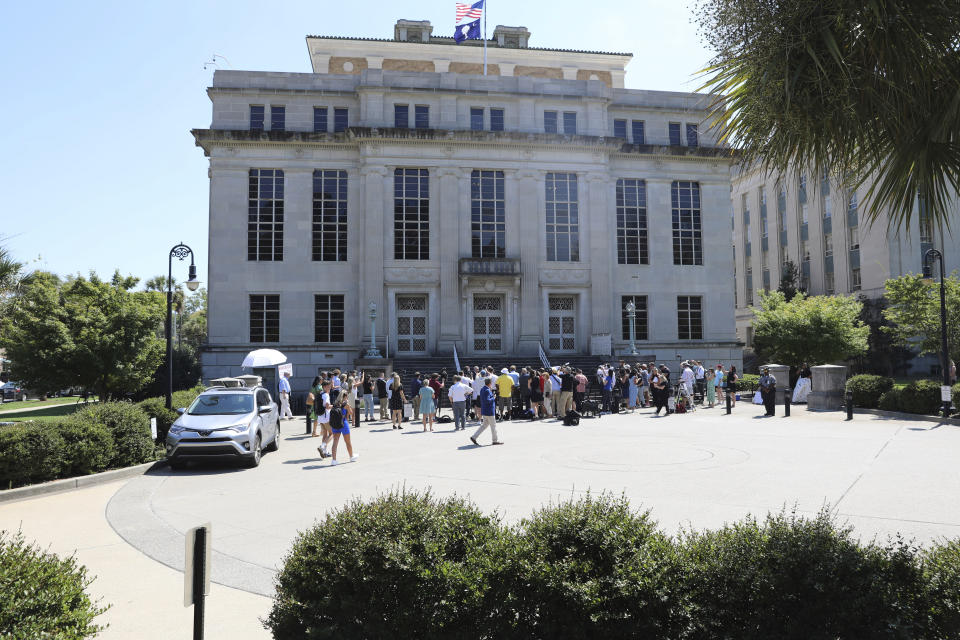 A crowd of reporters gathers outside of the South Carolina Court of Appeals as Alex Murdaugh's attorneys prepare for a news conference after filing an appeal of Murdaugh's double murder conviction on Tuesday, Sept. 5, 2023, in Columbia, S.C. Attorneys for convicted murder Alex Murdaugh want a new trial, accusing the court clerk of improperly influencing the jury. (AP Photo/Jeffrey Collins)