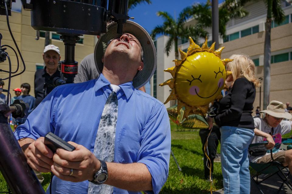 Eric Vandernoot, astronomy and physics lab coordinator and manager at FAU Astronomical Observatory looks through a telescope during a solar eclipse viewing event at Florida Atlantic University on April 8, 2024, in Boca Raton, Fla.