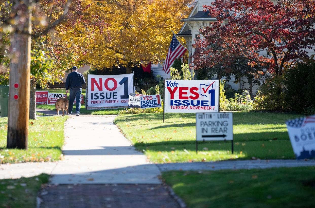 Two oversized signs addressing Issue One are on display along Fifth Street in Marysville, Ohio.