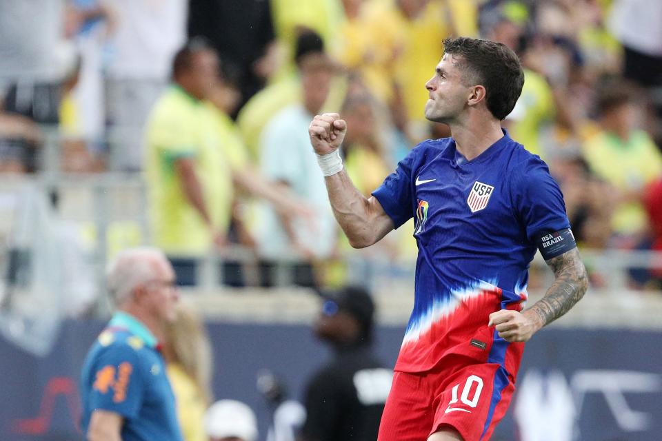 USA's forward #10 Christian Pulisic celebrates scoring his team's first goal during the Continental Clasico 2024 international friendly football match between USA and Brazil at the Camping World Stadium in Orlando, Florida, June 12, 2024. (Photo by Gregg Newton / AFP) (Photo by GREGG NEWTON/AFP via Getty Images)