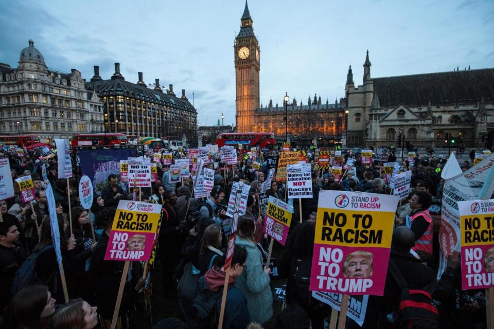 Rally: Protesters holding placards take part in a rally in Parliament Square (Getty Images)