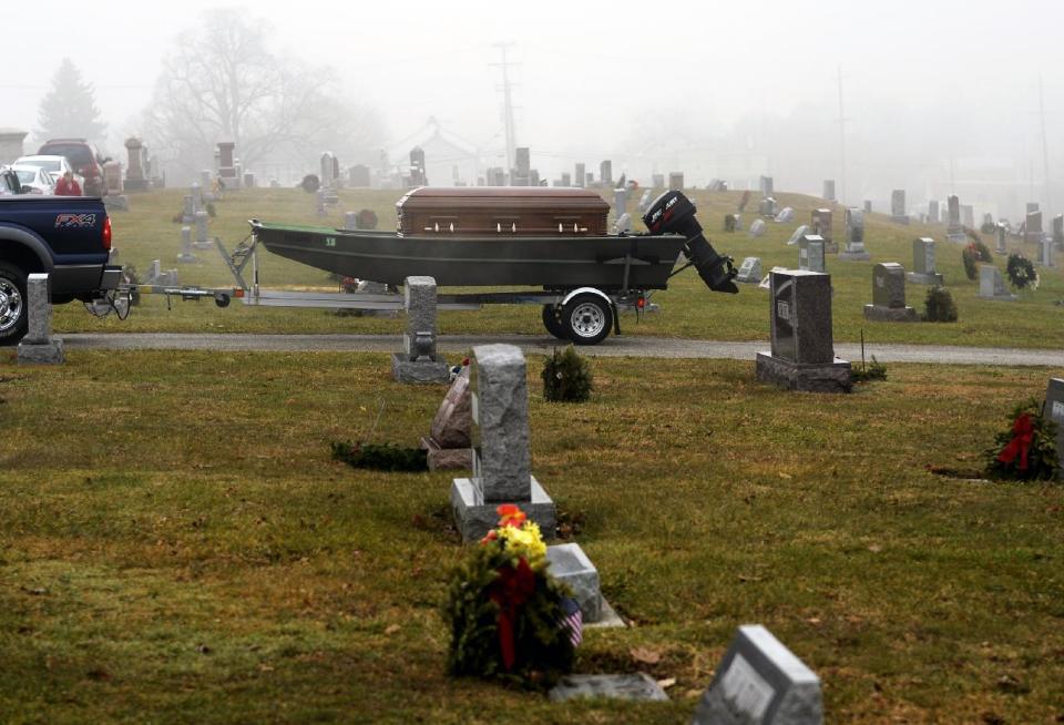 A pickup truck tows a flat-bottom jon boat carrying the casket of Ronald "Manny" Bloss Sr., 78, to his burial plot in Manchester Union Cemetery in Manchester, Pa. on Wednesday, Jan. 15, 2014. Bloss died Saturday, Jan. 11, of terminal cancer. Per his wishes, the outdoorsman and Korean War veteran made his final journey via his jon boat _ in his casket _ from the Diehl Funeral Home & Cremation Center in Mount Wolf to his Manchester Union Cemetery burial plot. (AP Photo/York Daily Record, Chris Dunn) YORK DISPATCH OUT